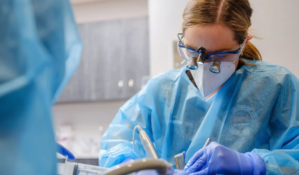 A close-up view of oral surgeon Dr. Amanda E. Suits performing a surgical procedure on a patient